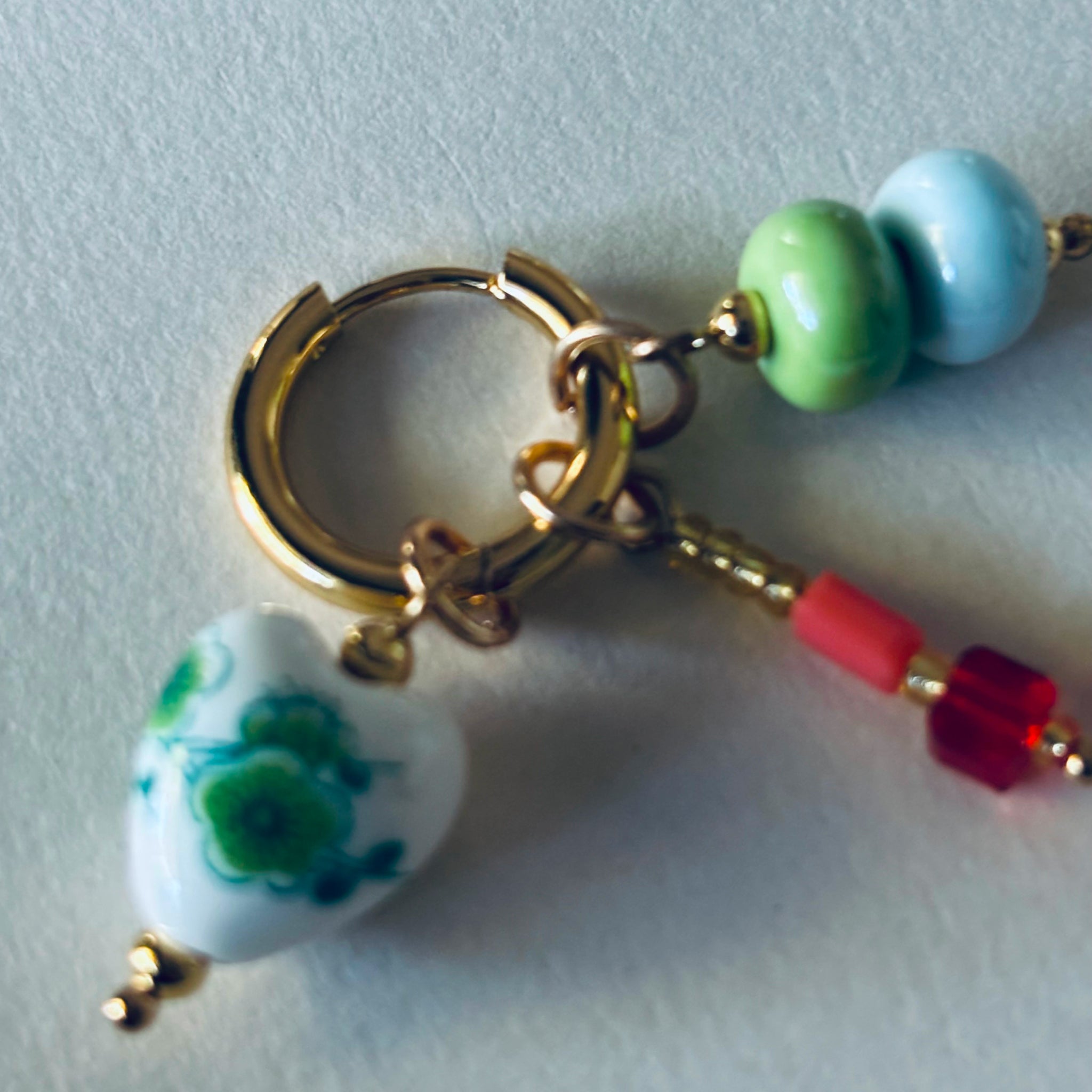 Earring with heart-shaped charm and beads