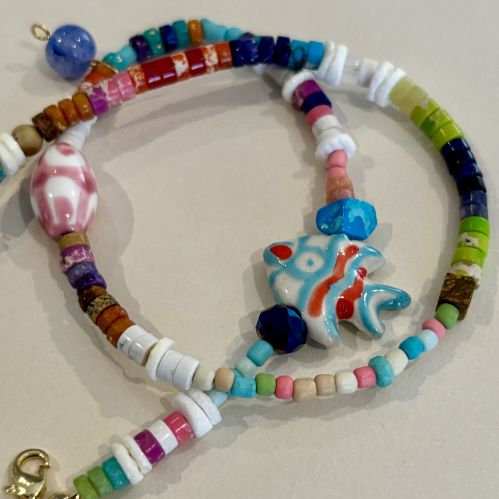 Colorful beaded bracelet with a fish-shaped charm