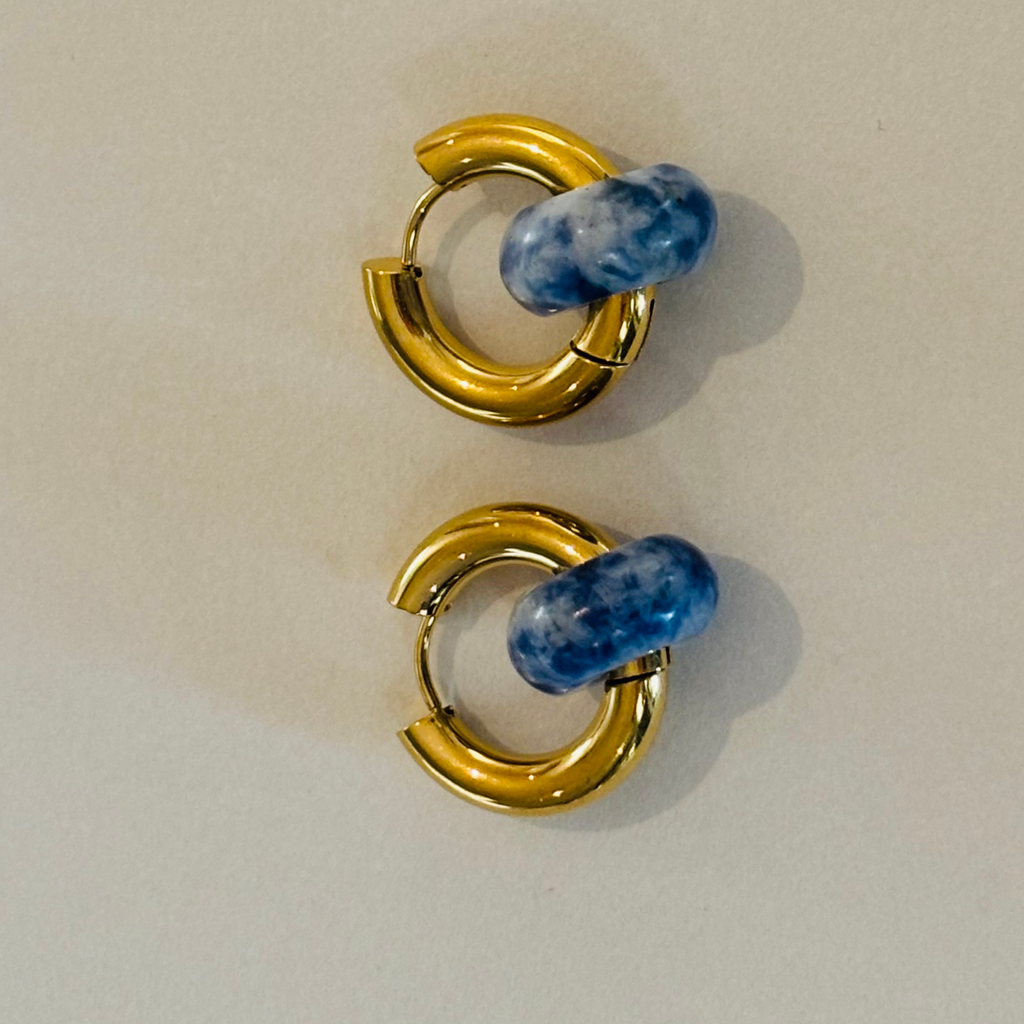 Pair of gold hoop earrings with blue gemstones