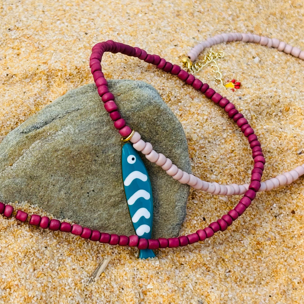 Necklace with a blue fish pendant