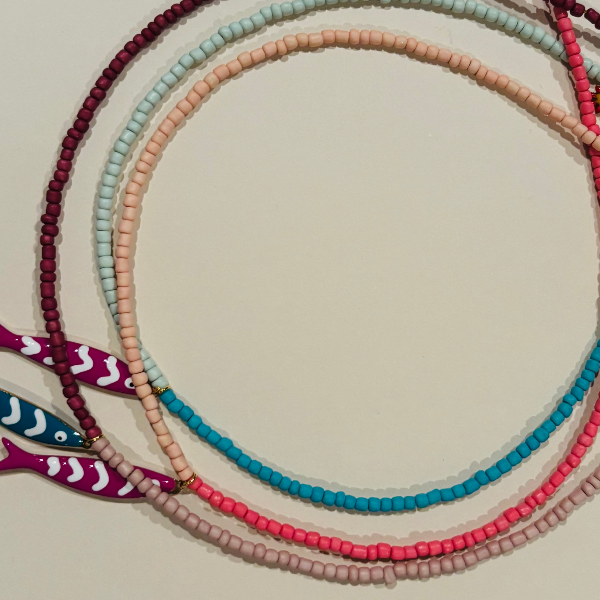 Colorful beaded necklaces with fish charms