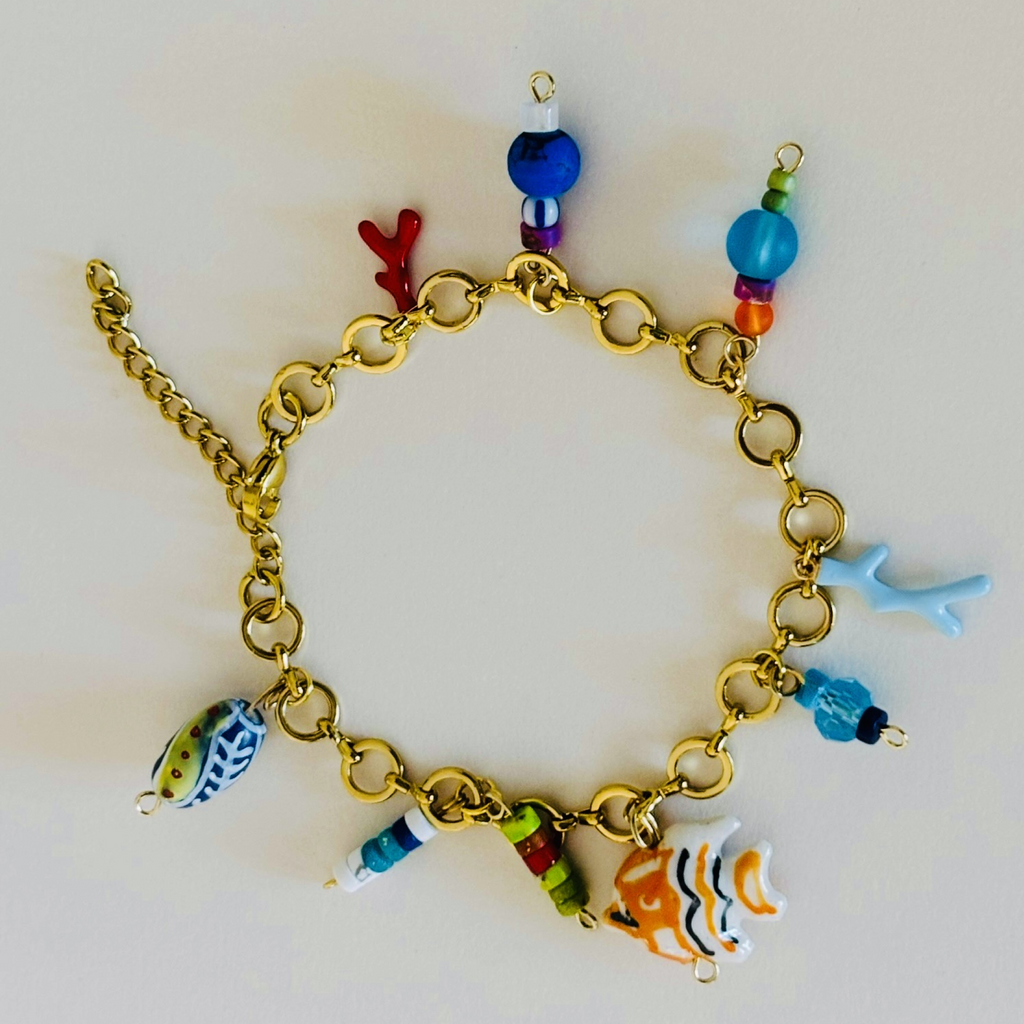 Gold chain bracelet with colorful fish and coral charms