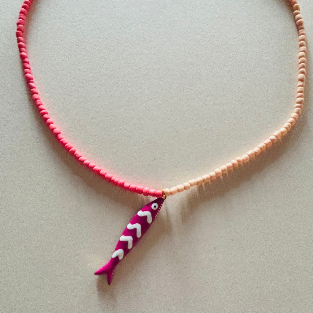 Necklace with a pink fish-shaped pendant