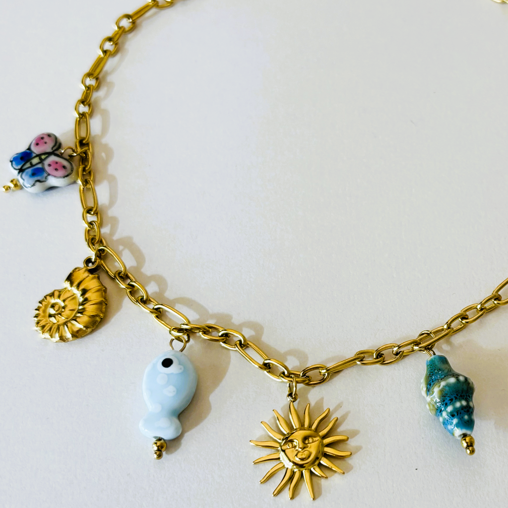 Gold chain bracelet with various charms