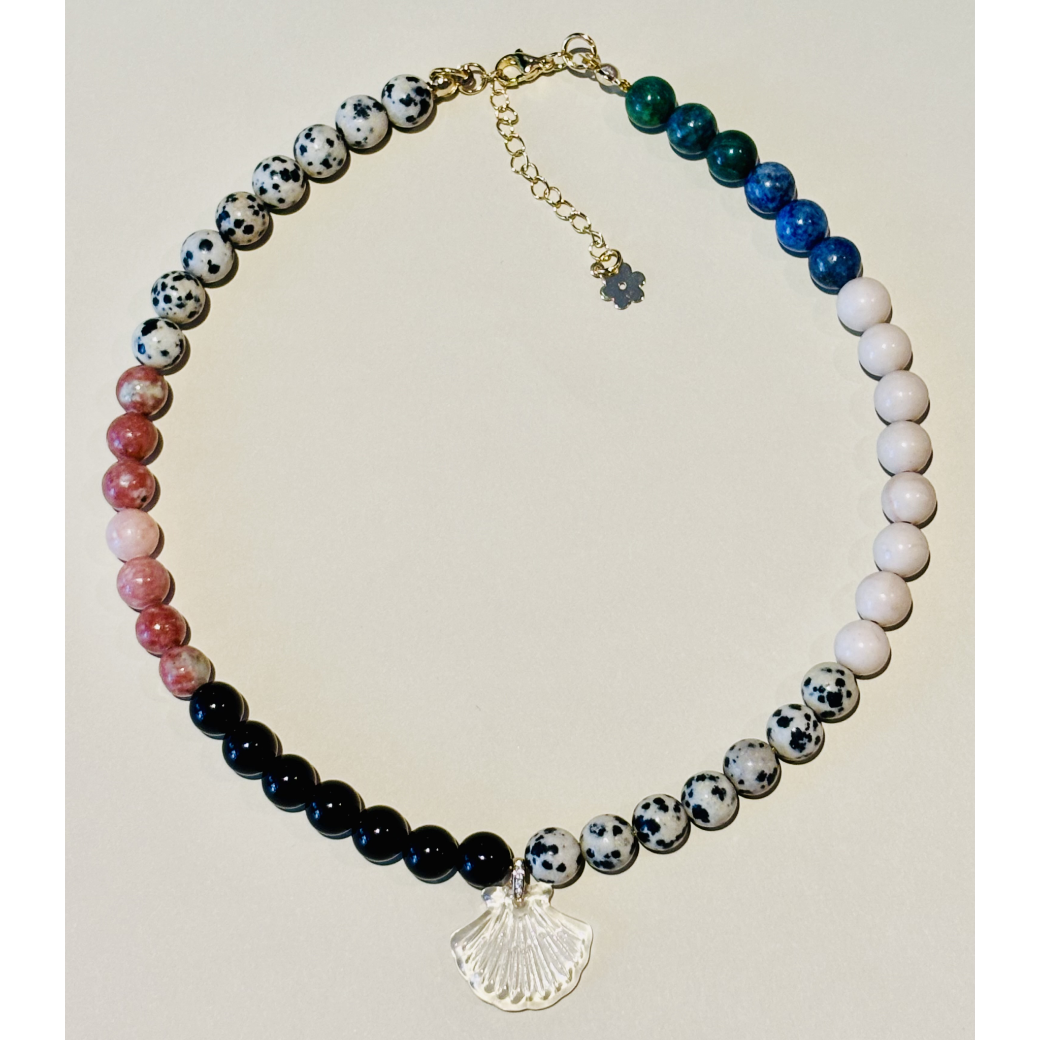 Handcrafted necklace with multicolored beads and a shell charm