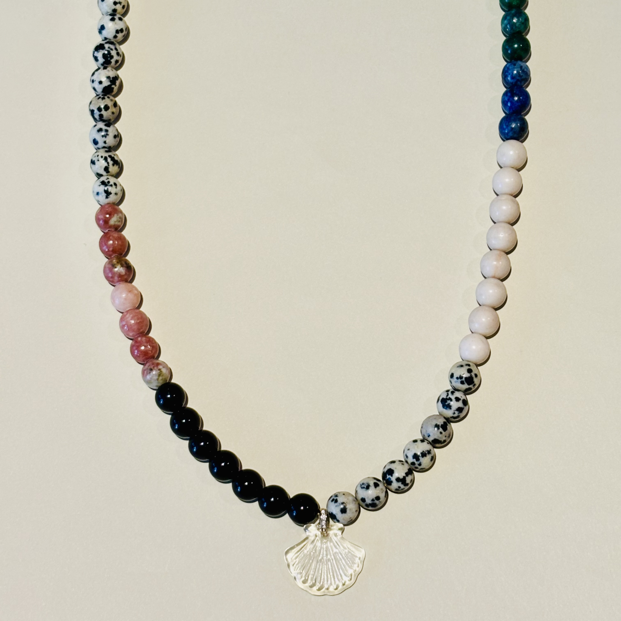 Necklace with multicolored beads and a shell pendant