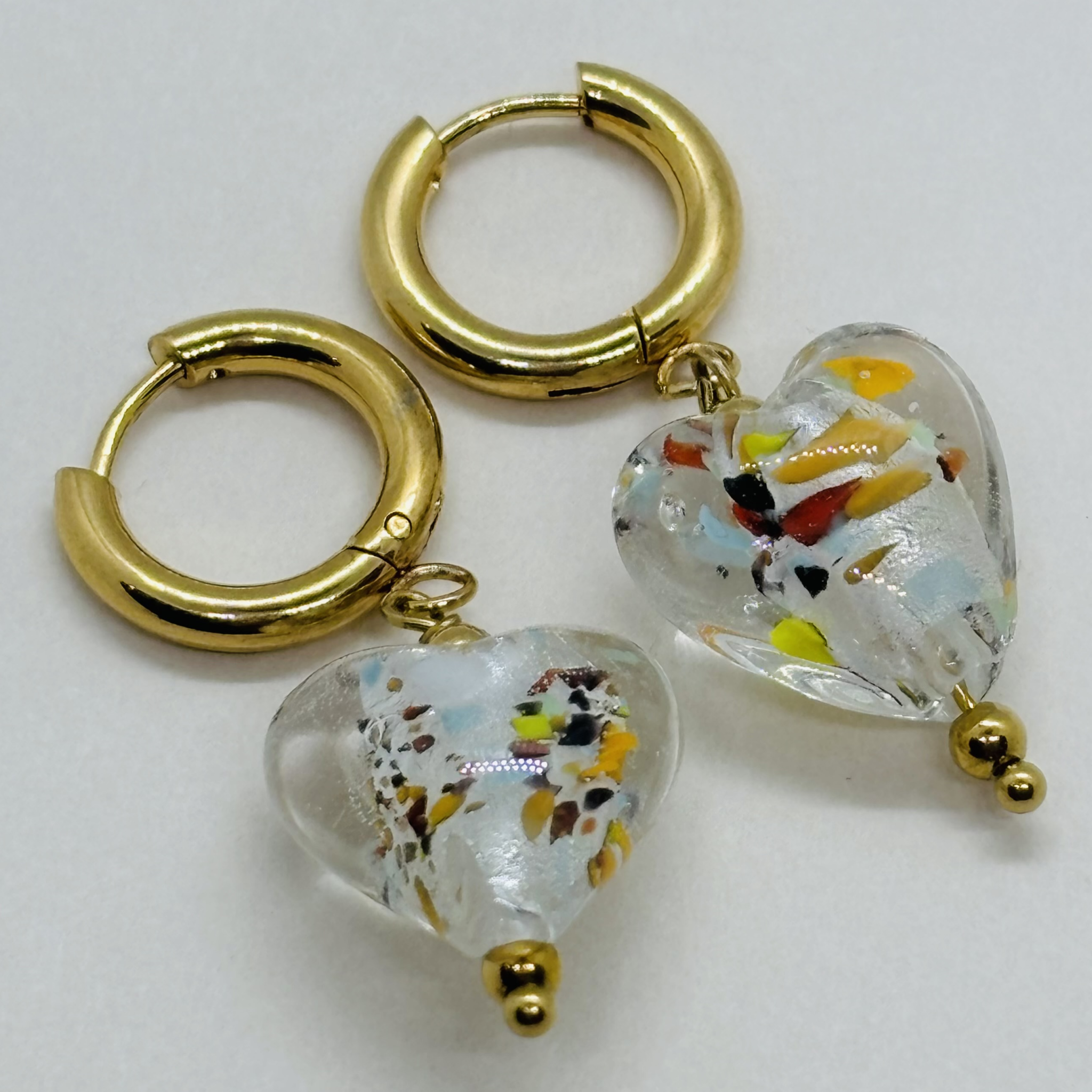 Handcrafted gold hoop earrings with heart-shaped glass pendants