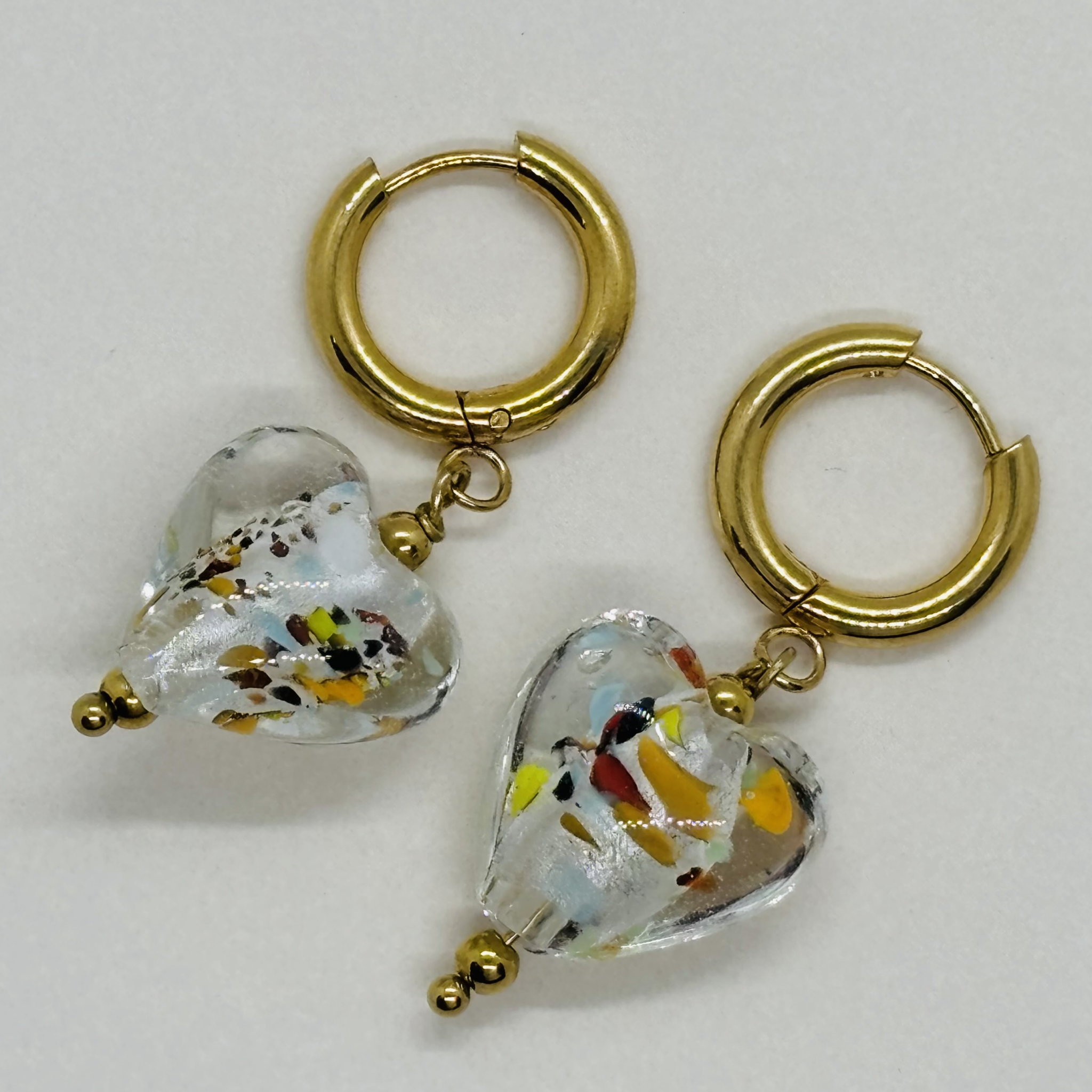 Handcrafted gold hoop earrings with heart-shaped glass charms