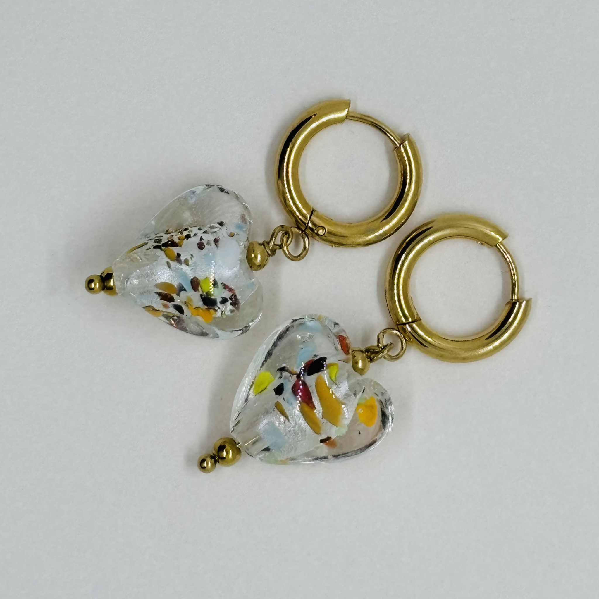 Handcrafted gold hoop earrings with heart-shaped glass charms