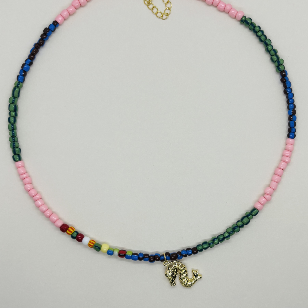 Handcrafted necklace with multicolored beads and a small charm