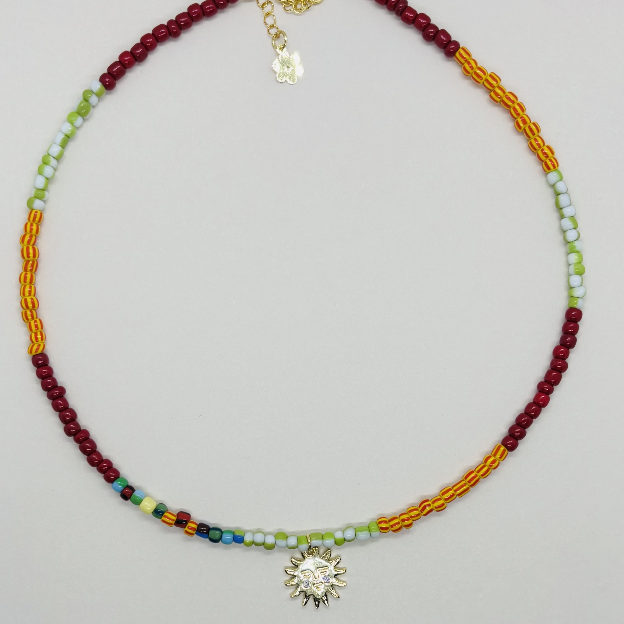 Necklace with colorful beads and a sunflower charm