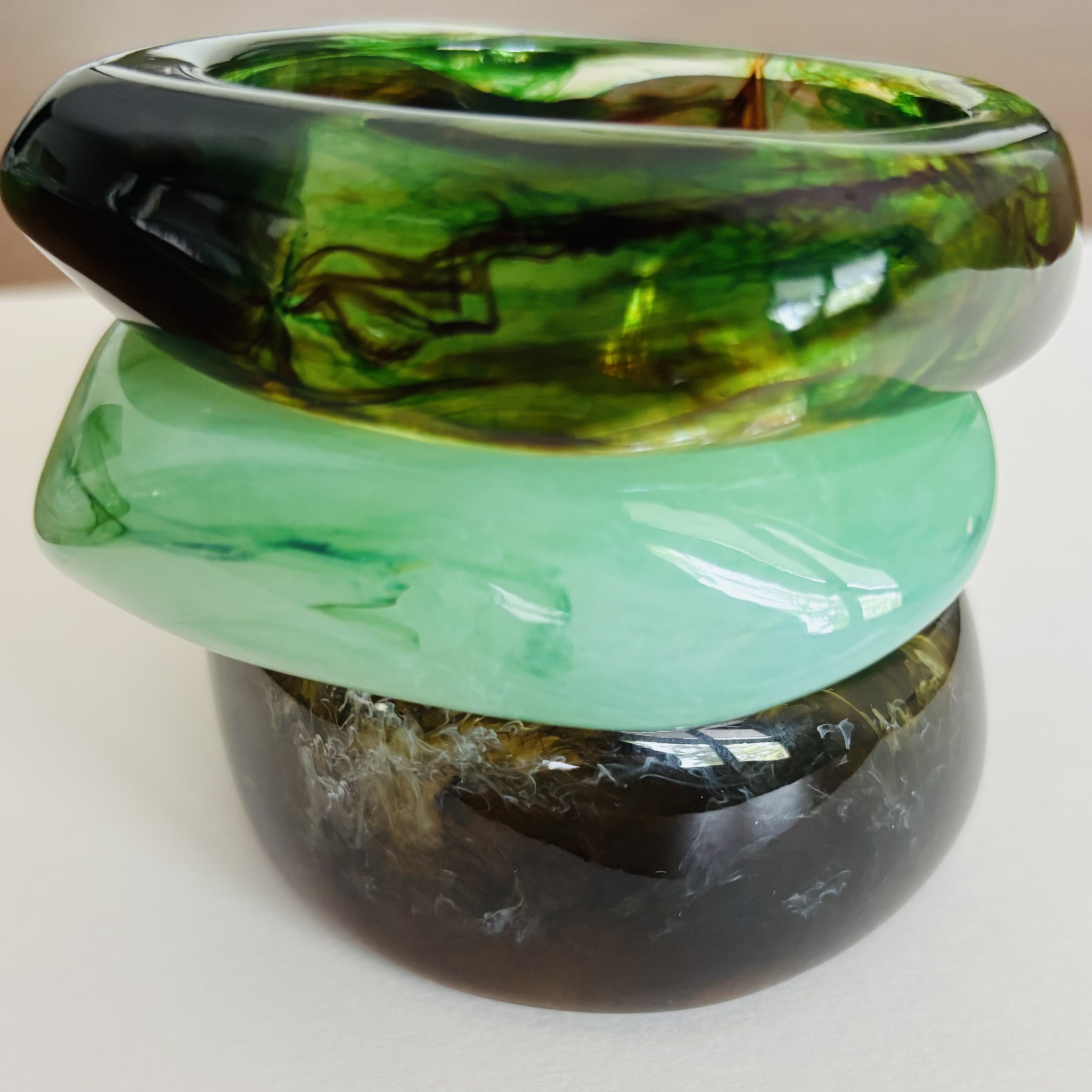 Three green and black handcrafted marbled bangles