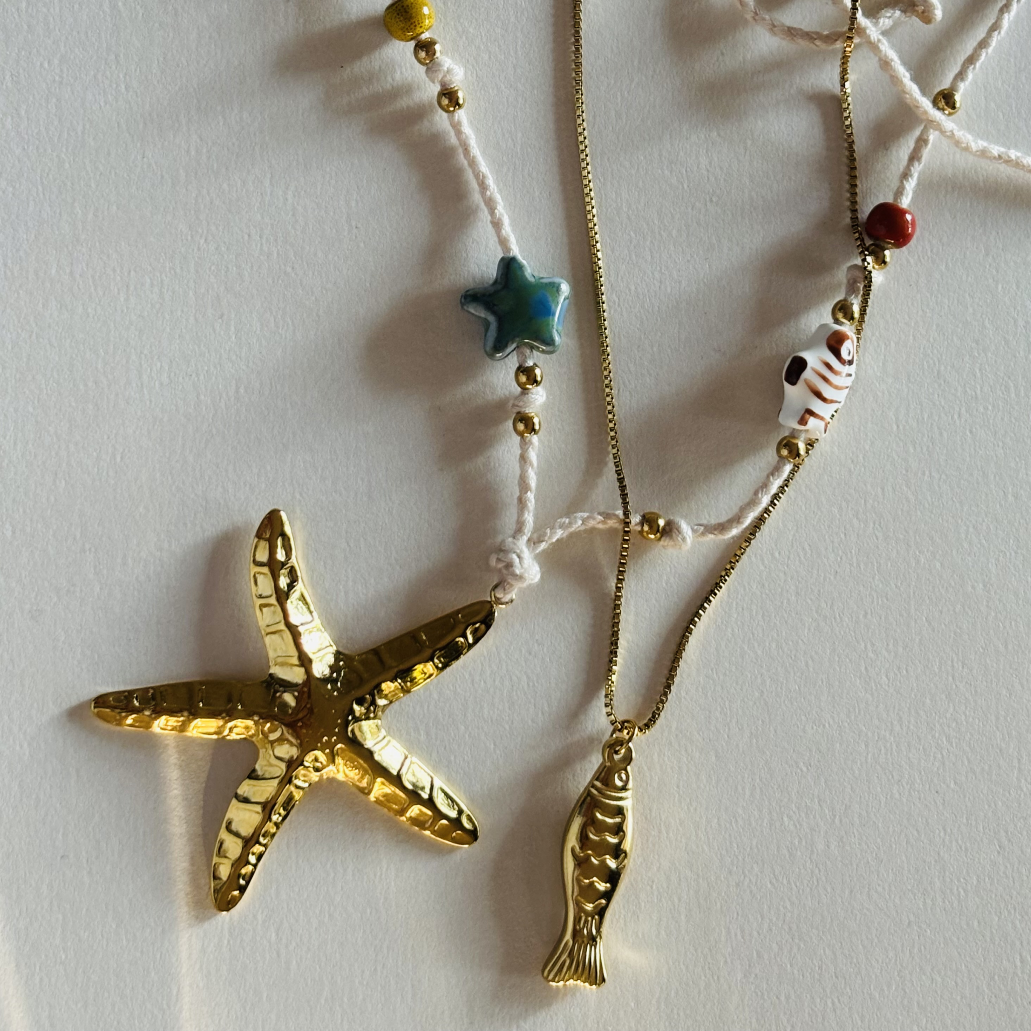 Necklace with starfish and fish pendants