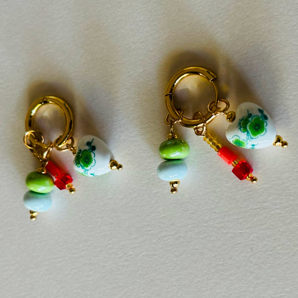 Pair of gold hoop earrings with colorful beads and charms