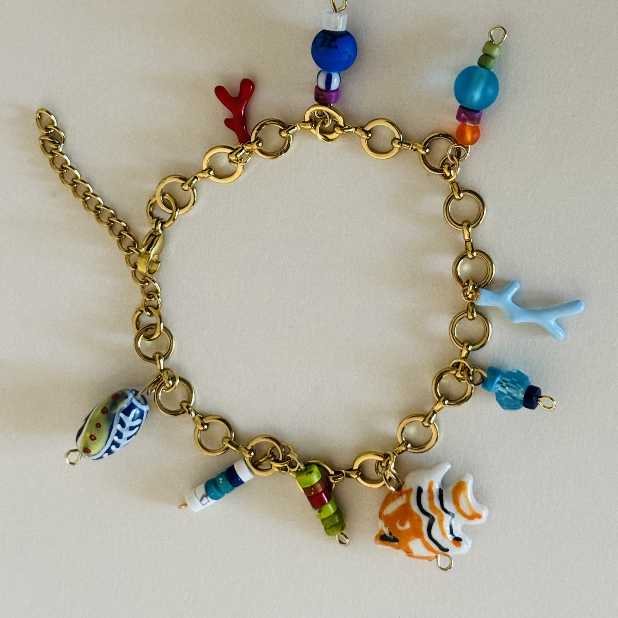 Gold bracelet with colorful charms