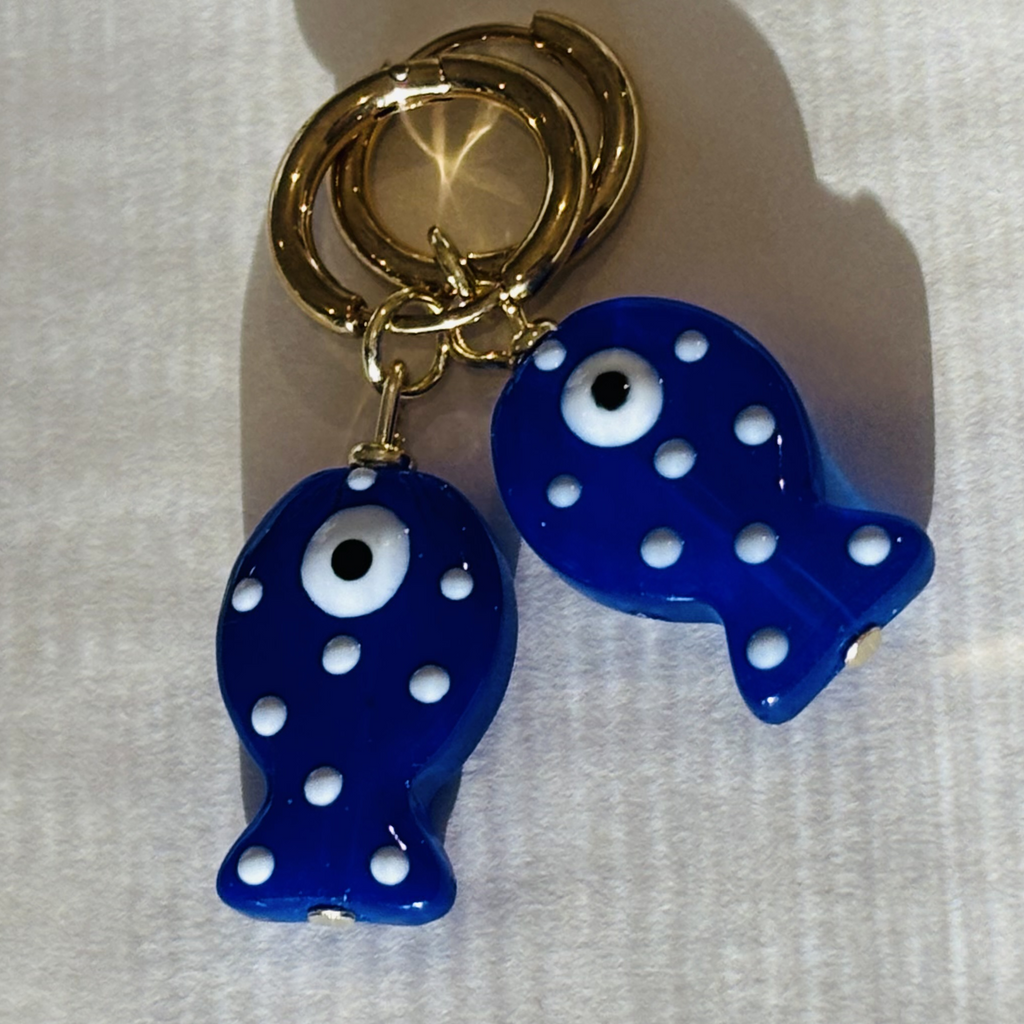 Blue fish-shaped earrings with white polka dots and gold rings