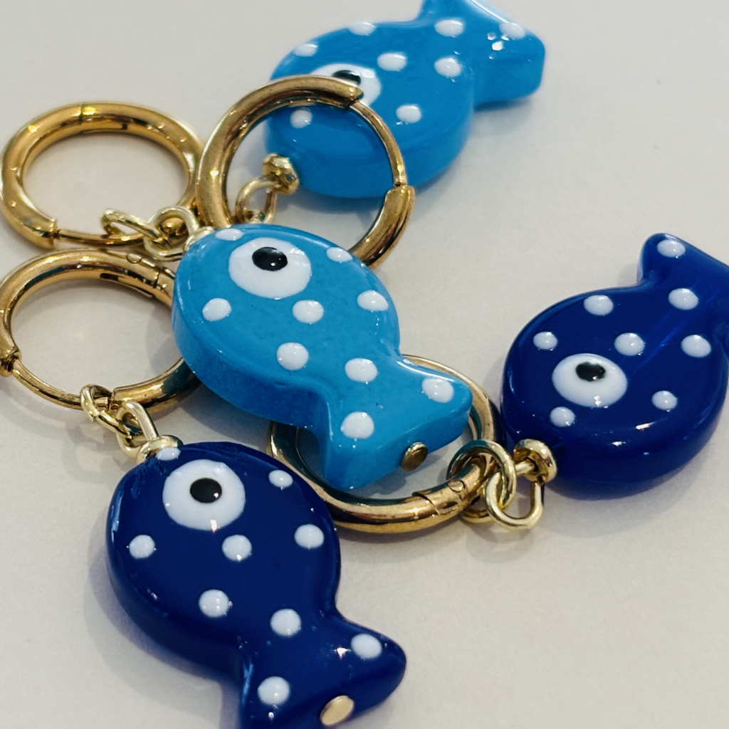 Blue fish-shaped earrings with white polka dots and gold hoops