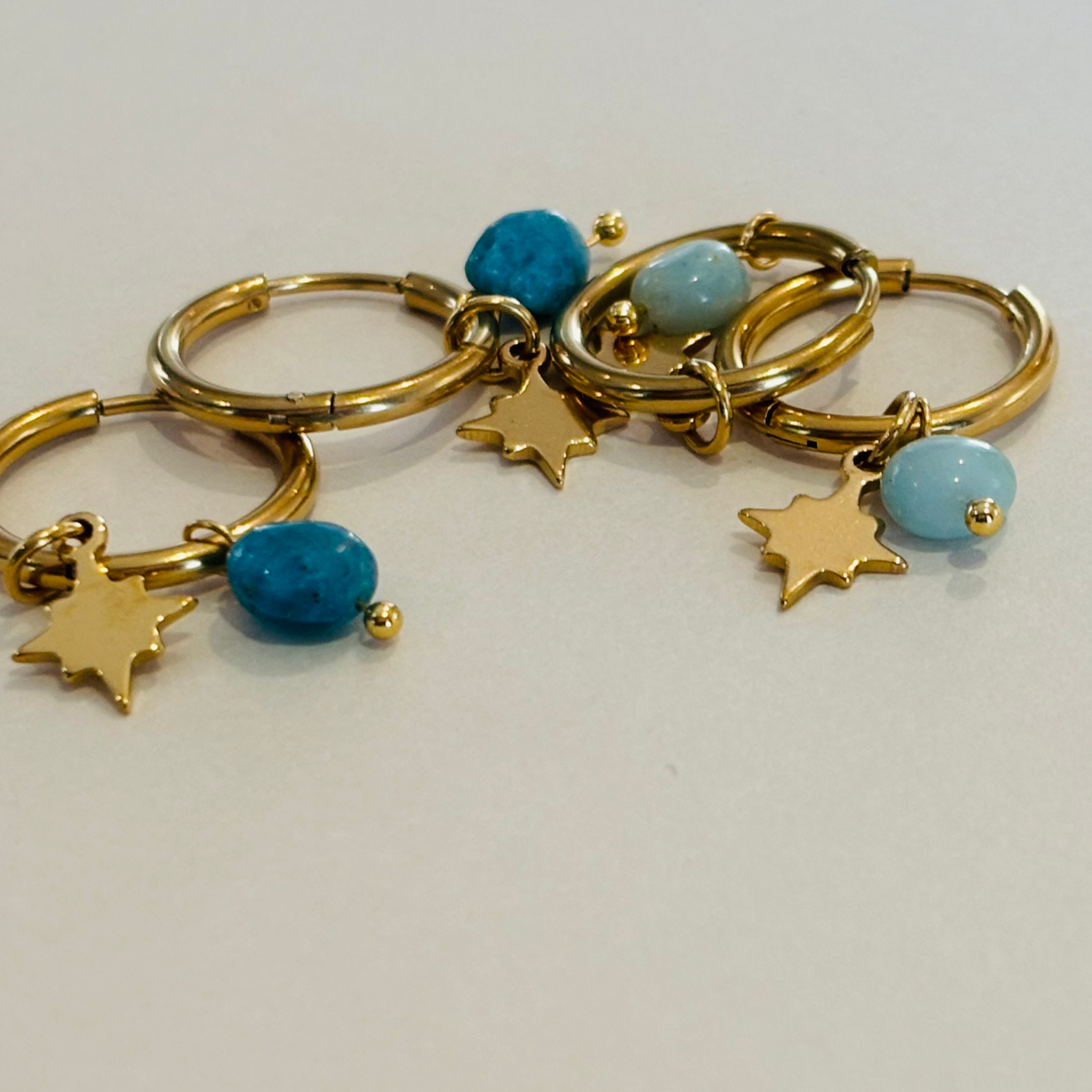 Gold hoop earrings with turquoise beads and star charms