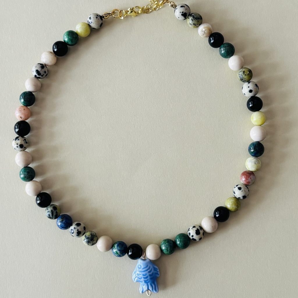 Handcrafted necklace with multicolored beads and a blue fish charm