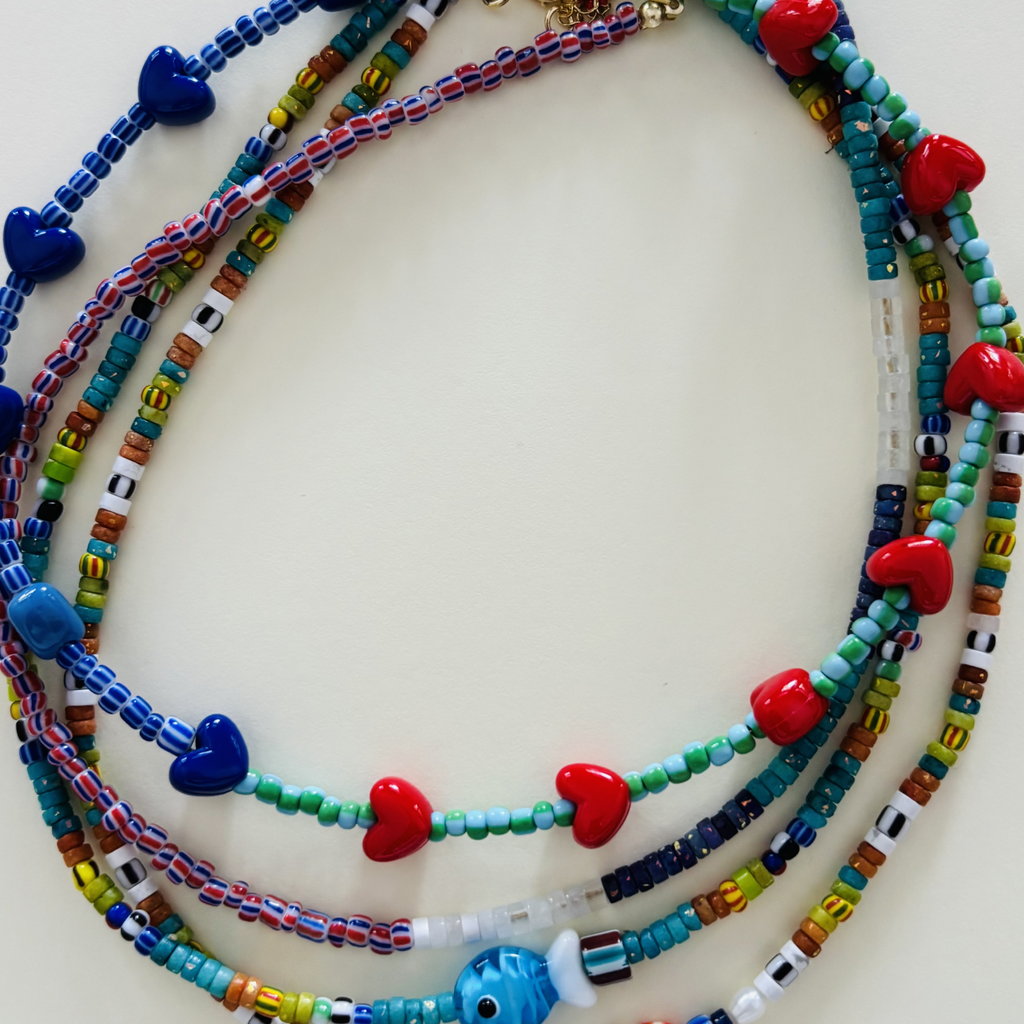 Colorful beaded necklaces with heart and fish charms