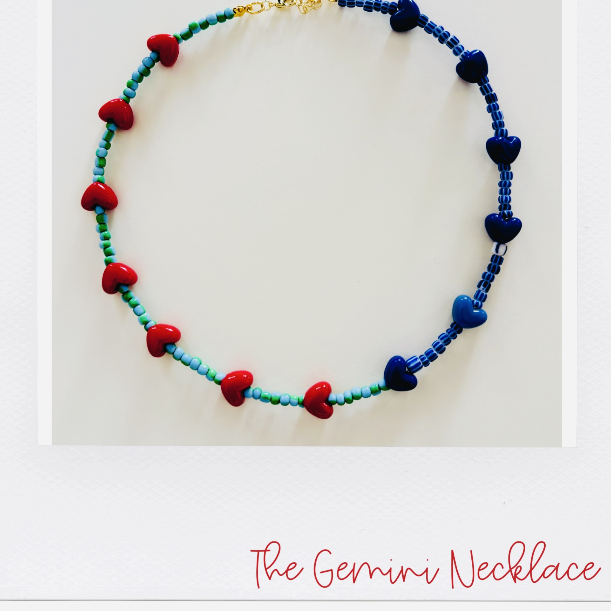 Necklace with heart-shaped beads in red, blue, and green.
