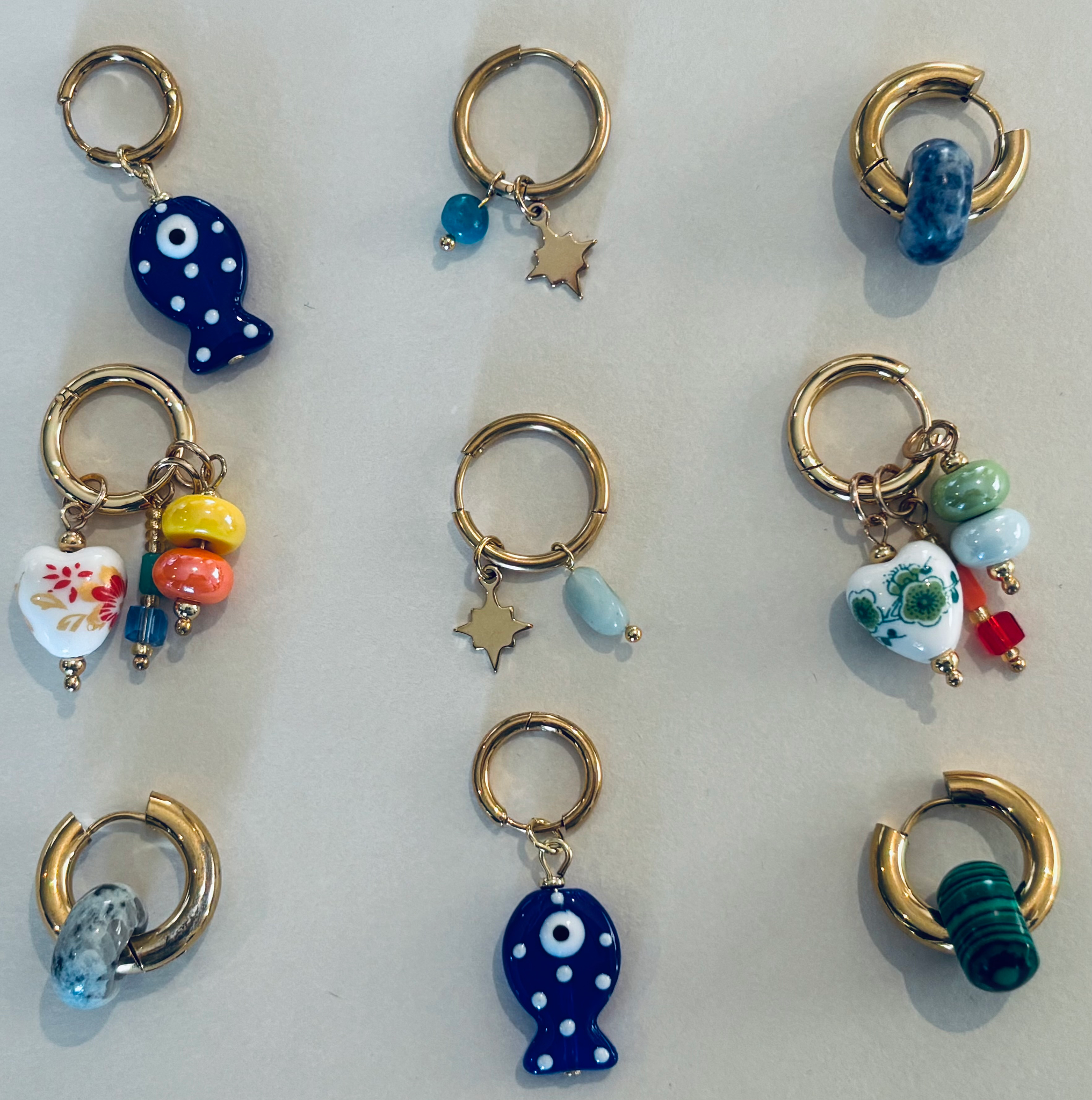 Collection of colorful earrings with various charms