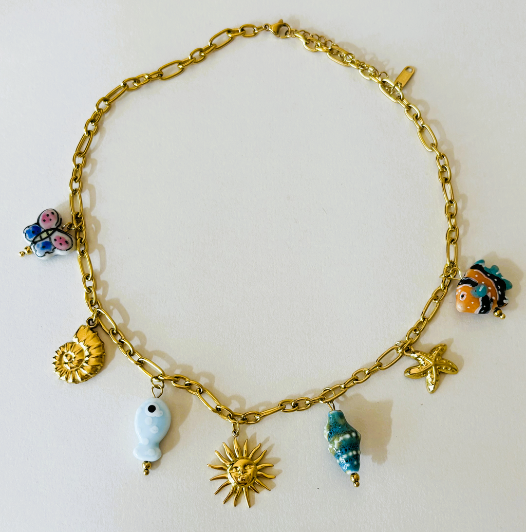Gold chain bracelet with various charms