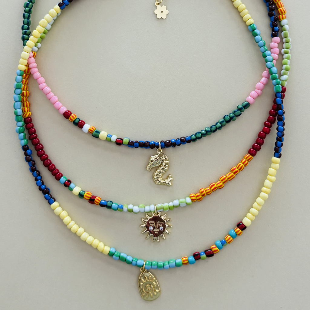 Three handcrafted colourful beaded necklaces with various pendants